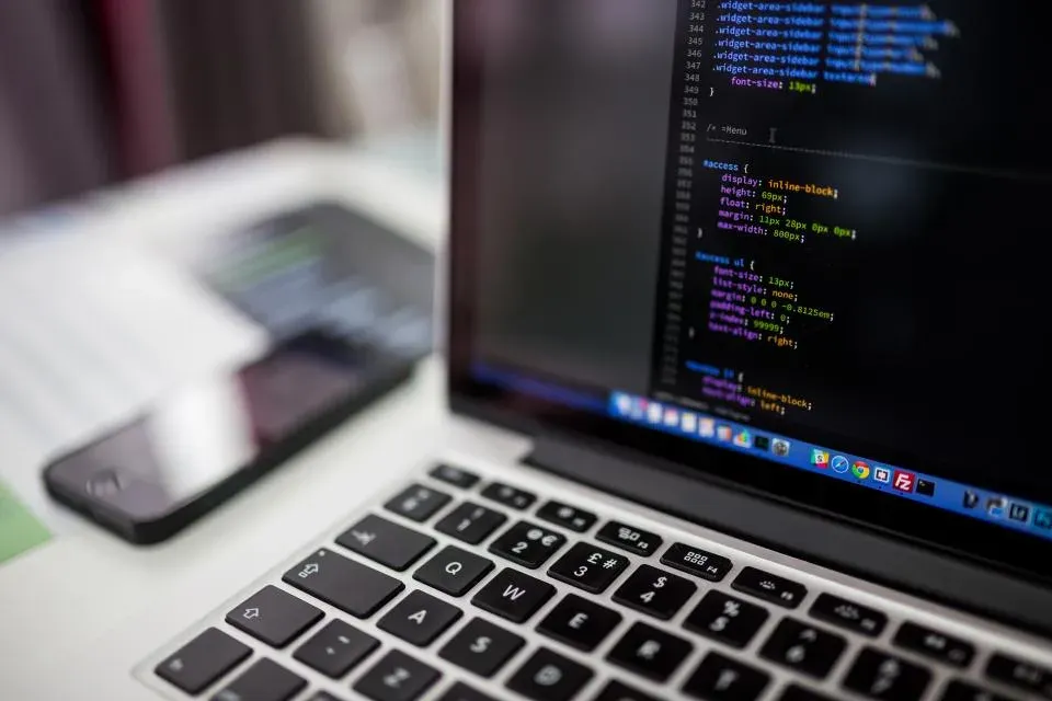 Laptop screen showing source code in a dark editor