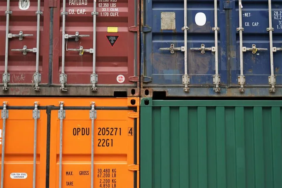 Stacked shipping containers in a logistics yard