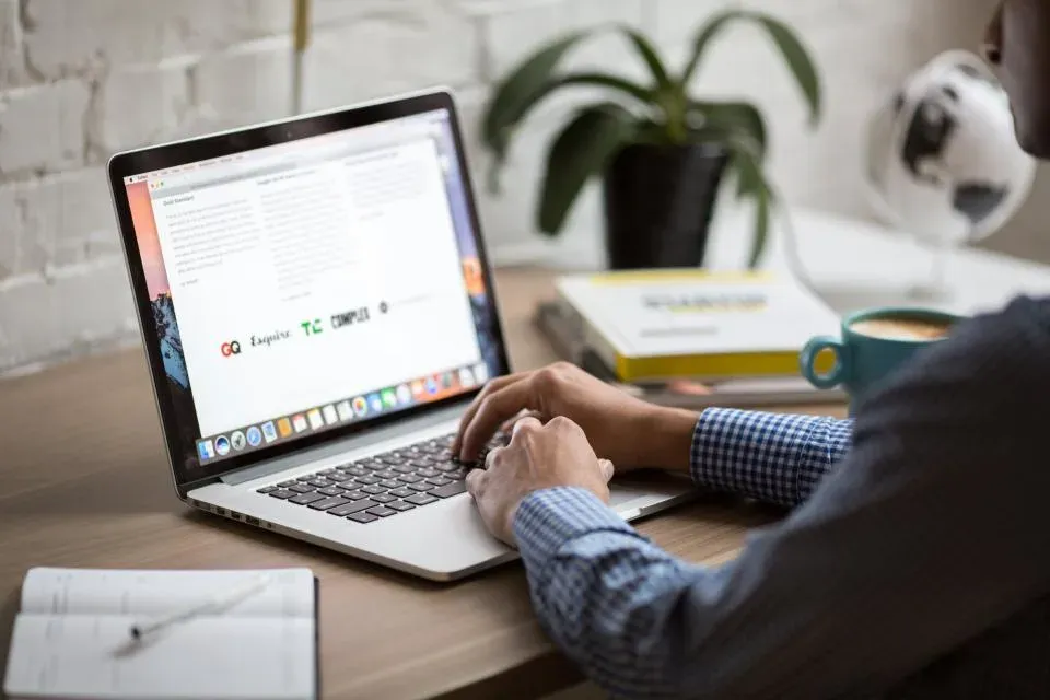 Laptop showing a web page on a wooden desk