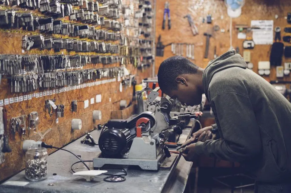 Engineer working at a bench in a parts workshop